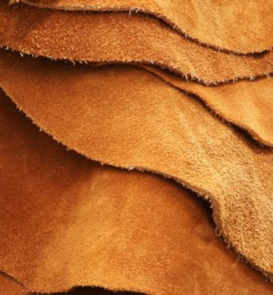 A leather jacket being cared for by skilled hands